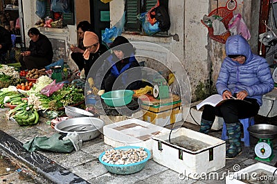 Streets of Vietnam - Fruits and fish sellers on the sidewalk Editorial Stock Photo