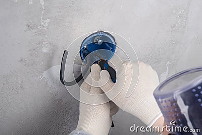 Strengthening the base of the electrical outlet before installing contacts, close-up of the master`s hands Stock Photo