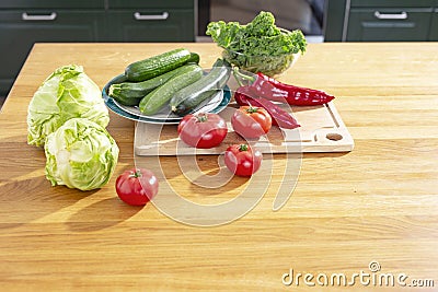 Fresh vegetables on the table. Kale cabbage, tomatoes, zucchini, cucumbers, paprika, white cabbage Stock Photo