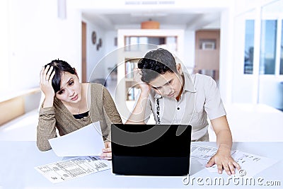 Stress couple paying bill online at home Stock Photo