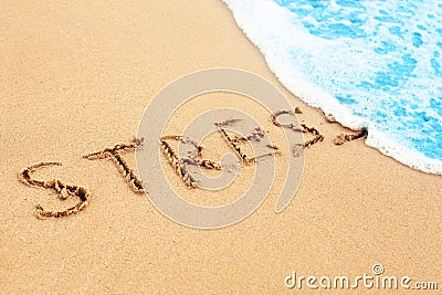 Stress free travel. The wave on sea beach washes away sign stress on sand Stock Photo