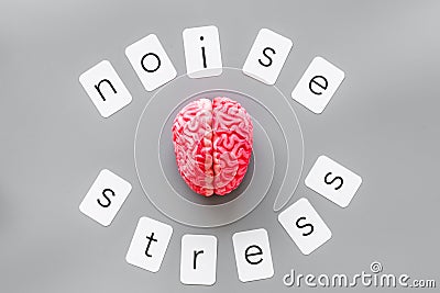 Stress and noise text with brain for psychological health in office concept on graybackground top view Stock Photo