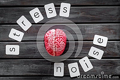 Stress and noise text with brain for psychological health in office concept on wooden background top view Stock Photo
