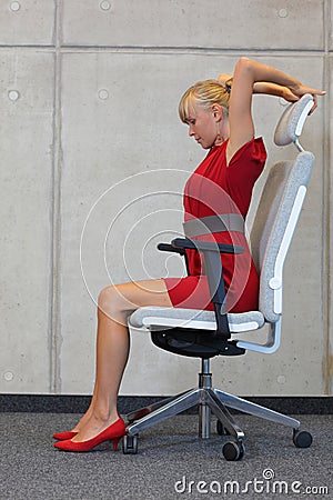 Stress reduction in office work - woman exercising on chair Stock Photo
