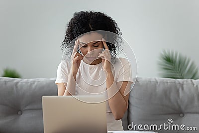 Unhealthy black woman having headache overwhelmed with computer work Stock Photo