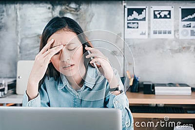 Stressed Asian creative designer woman cover her face with hand Stock Photo