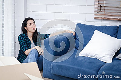 Stressed Asian woman moving things into a new home. Stock Photo