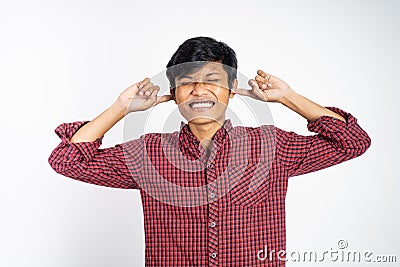 frustrated asian young businessman cover his ear Stock Photo