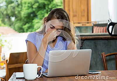 Stressed blonde woman at computer Stock Photo
