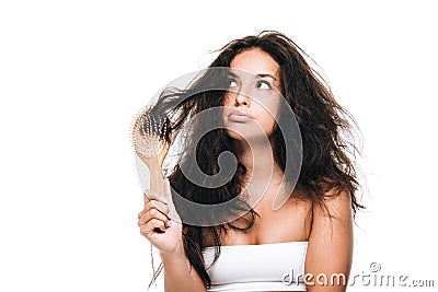 Brunette woman with wavy unruly hair in comb looking away isolated on white Stock Photo