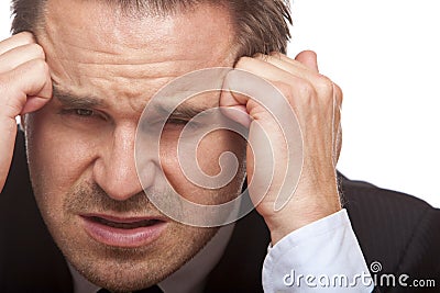 Stressed business man has bad headache in office Stock Photo