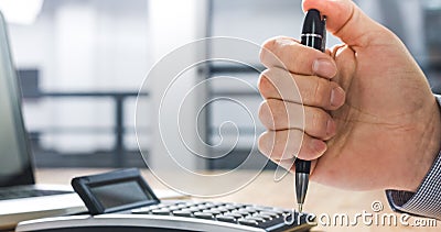 Stressed businessman clicking on pen Stock Photo