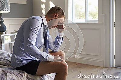 Stressed Businessman Getting Dressed For Work Stock Photo