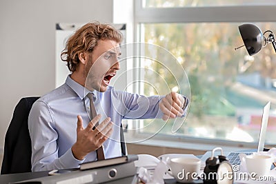 Stressed businessman missing deadlines in office Stock Photo