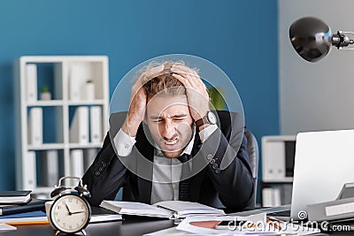 Stressed businessman missing deadlines in office Stock Photo
