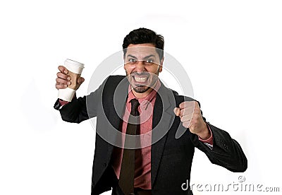 Stressed businessman in suit and tie crushing empty cup of take away coffee in caffeine addiction concept Stock Photo