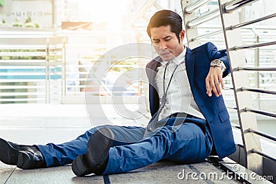 Stressed businessman worry financial bankruptcy. Depressed asian male sitting on the street tired after failed to rescue company Stock Photo