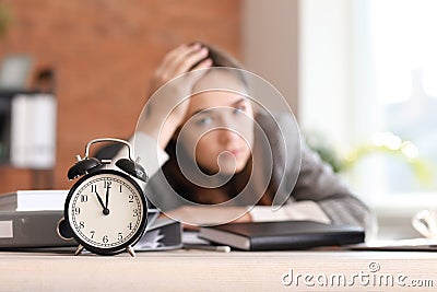 Stressed businesswoman missing deadlines in office Stock Photo