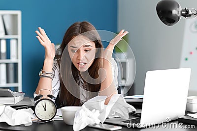 Stressed businesswoman missing deadlines in office Stock Photo