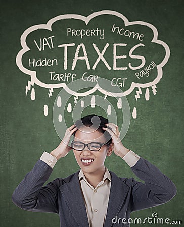 Stressed businesswoman for paying her taxes Stock Photo