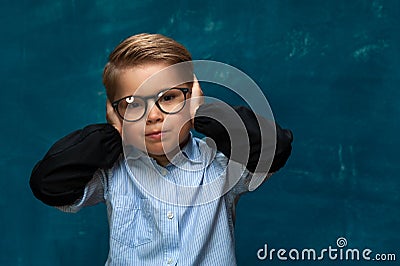 Stressed child wearing eyeglasses and shirt Stock Photo