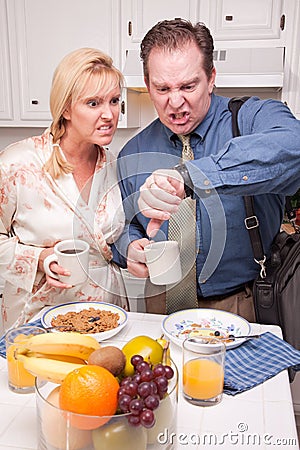 Stressed Couple in Kitchen Late for Work Stock Photo