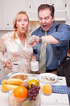 Stressed Couple in Kitchen Late for Work Stock Photo