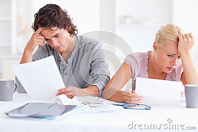 Stressed Couple with Paperwork Stock Photo