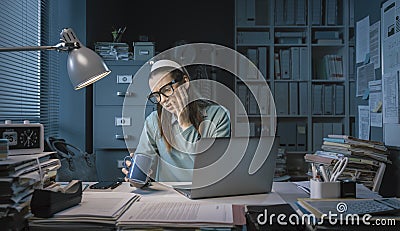 Stressed employee drinking coffee in the office Stock Photo