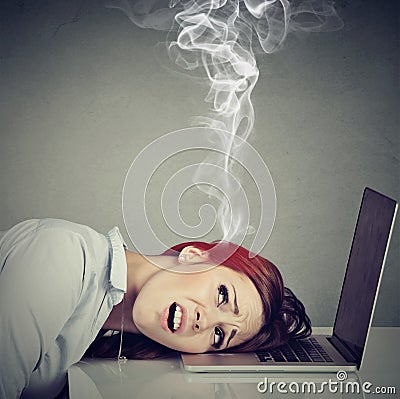 Stressed employee woman with overheated brain using laptop Stock Photo