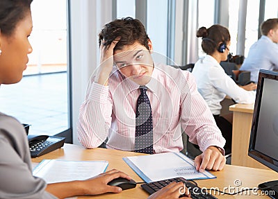 Stressed Employee Working In Busy Office Stock Photo