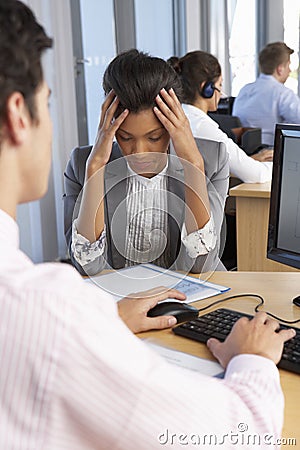 Stressed Employee Working In Busy Office Stock Photo