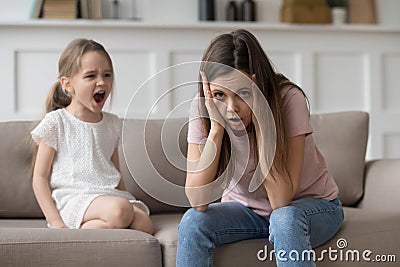 Stressed mother feeling desperate about screaming stubborn kid daughter tantrum Stock Photo