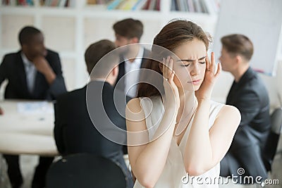 Stressed female corporate employee having migraine during briefi Stock Photo