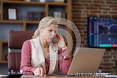 Stressed female trader desperate about losing money analyzing stock exchange market. Tired businesswoman recieved bad Stock Photo