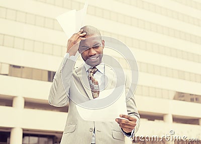 Stressed frustrated man holding looking at documents Stock Photo