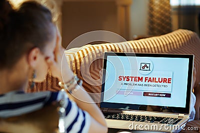 Stressed housewife experiencing computer fault on laptop Stock Photo