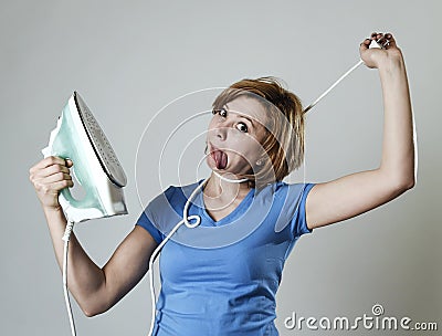 Stressed housewife or maid domestic service woman holding upset iron strangling neck with cable Stock Photo