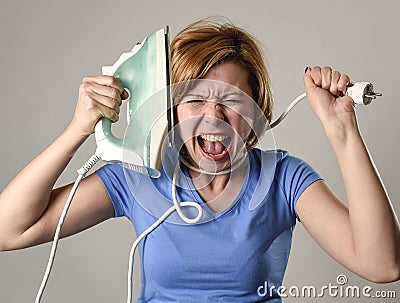 Stressed housewife or maid domestic service woman holding upset iron strangling neck with cable Stock Photo