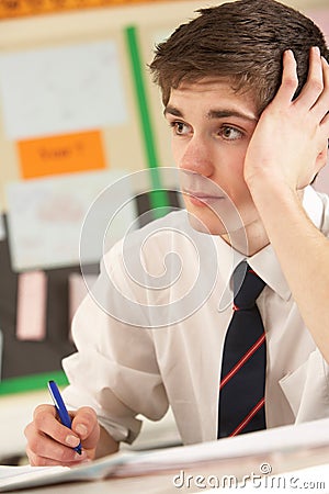 Stressed Male Teenage Student Studying Stock Photo