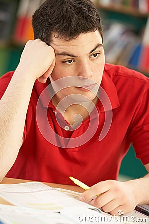 Stressed Male Teenage Student Studying Stock Photo