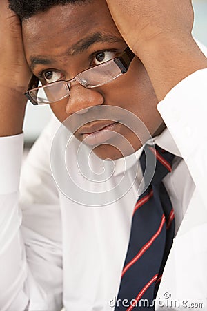 Stressed Male Teenage Student Studying Stock Photo