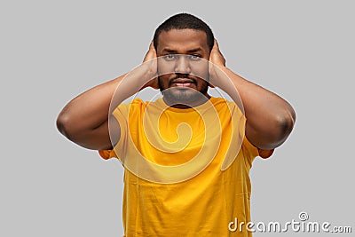 Stressed man closing his ears with hands Stock Photo