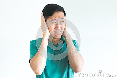 Stressed man covering his ears and do not want to hear, noise too loud. Stock Photo