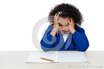 Stressed out primary girl child holding her head Stock Photo