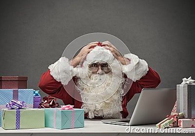 Stressed Santa connecting with his laptop Stock Photo