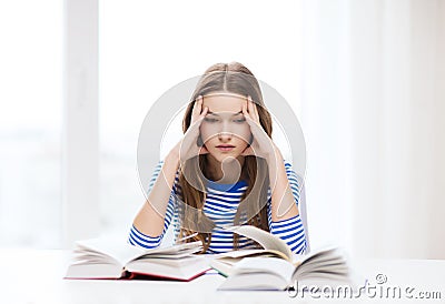 Stressed student girl with books Stock Photo