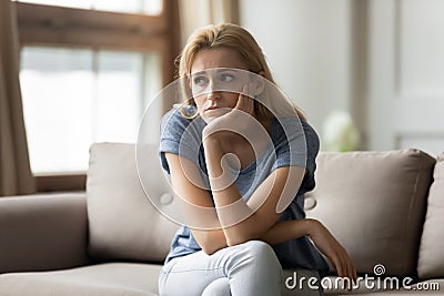 Stressed upset young blonde woman thinking of personal troubles. Stock Photo