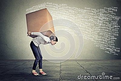 Stressed woman carrying on her back large box Stock Photo