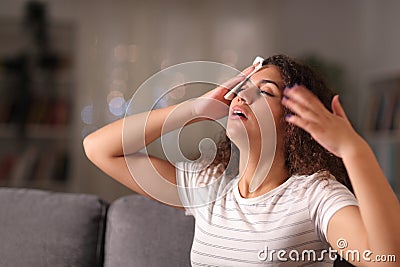 Stressed woman drying sweat in a warm night at home Stock Photo